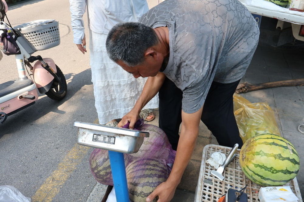 高温下的济南街头，瓜农守着“最甜”营生，扛起一家人的烟火生计