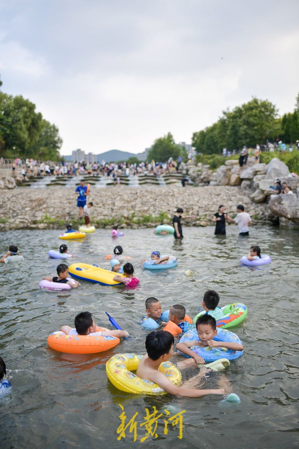 三伏天高温持续 滨水公园里戏水纳凉